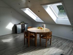 a dining room with a table and some skylights at Ferienwohnung Noli in Tuttlingen