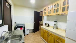 a kitchen with a sink and a counter top at Cabañas Del Maule II in Talca