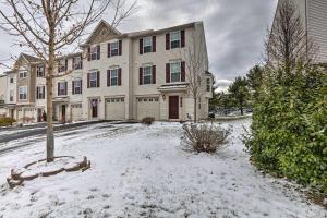 a house with snow on the ground in front of it at Bellefonte Townhouse - 9 Miles to Penn State! in Bellefonte