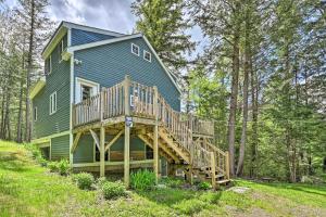 een groot blauw huis met een terras in het bos bij Cabin in the Untouched Woods - 3 Miles to Ski in Jay