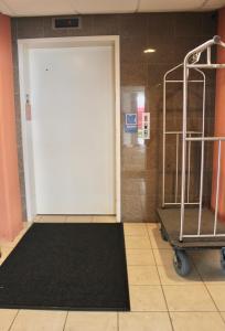 a large white door in a room with a black rug at Ebb Tide Suites in Ocean City