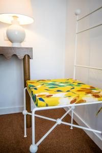 a bed in a room with a table and a lamp at Hôtel Le Sud in Juan-les-Pins