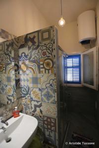 a bathroom with a shower and a sink at Il Cortiletto su levanzo in Favignana +10 photos