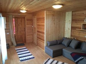 a living room with a couch and wooden walls at Vahtra Beach House in Käsmu