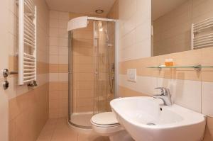 a bathroom with a toilet and a sink and a shower at Ruby Blue in Ostrava