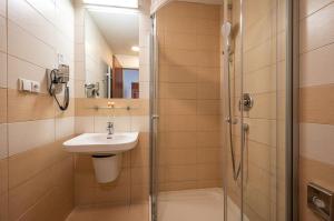 a bathroom with a shower and a sink and a shower at Ruby Blue in Ostrava