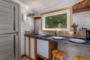 a kitchen in a tiny house with a sink and a window at Tiny house with terrace in Flåm
