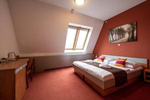 a bedroom with a bed and a sink and a window at Ruby Blue in Ostrava