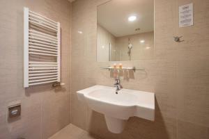a bathroom with a sink and a mirror at Ruby Blue in Ostrava