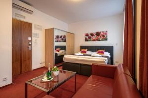 a hotel room with a bed and a couch at Ruby Blue in Ostrava