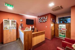 a fast food restaurant with a counter and a refrigerator at Ruby Blue in Ostrava
