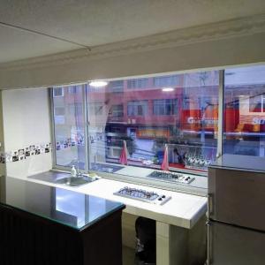 a kitchen with two sinks and a large window at Hotel Juanambu in Pasto