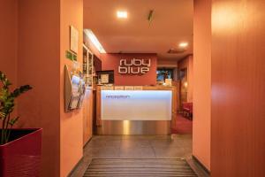 a lobby with a large sign in a restaurant at Ruby Blue in Ostrava
