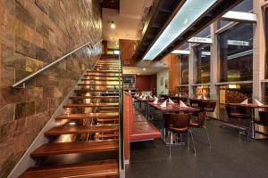 a staircase in a restaurant with tables and chairs at Ruby Blue in Ostrava