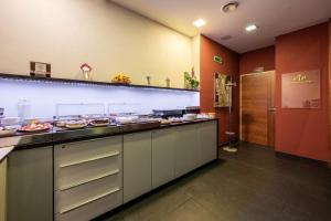 a large kitchen with many plates of food on a counter at Ruby Blue in Ostrava