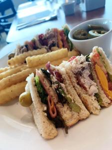 a sandwich and french fries on a white plate at Hotel Ankara "Las Lomas" in San Luis Potosí