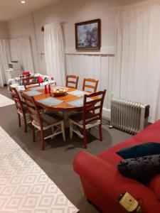 a dining table and chairs in a living room at Intrepid Bed & Breakfast in Christchurch
