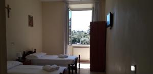 Cama ou camas em um quarto em Ostello Villa Monte Mario