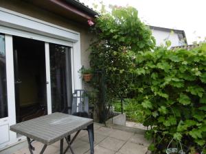 a table sitting on a patio next to a house at shirley in Villars-les-Dombes