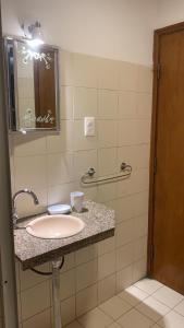 a bathroom with a sink and a mirror at Cabañas Marcelo in Barra del Chuy