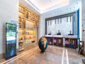 a lobby of a store with a globe in the middle at Kyriad Marvelous Hotel Guiyang Future Ark in Guiyang