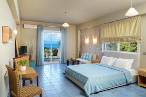 a bedroom with a bed and a living room at Kohylia by La Scala Beach in Limenas