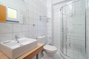 a bathroom with a sink and a toilet and a shower at Kohylia by La Scala Beach in Limenas