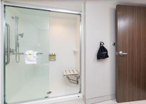 a bathroom with a toilet and a shower stall at Holiday Inn Express Pensacola Beach, an IHG Hotel in Pensacola Beach