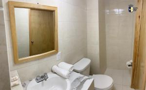 a bathroom with a sink and a toilet and a mirror at Hotel Real GDL in Guadalajara