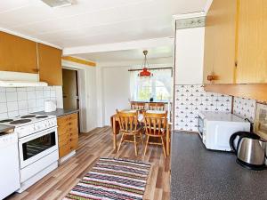 a kitchen with a table and chairs in it at 7 person holiday home in LMEDBODA in Älmeboda