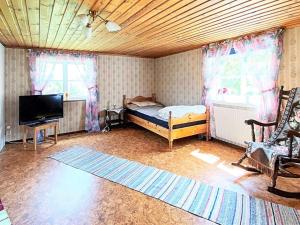 a bedroom with a bed and a tv in a room at 7 person holiday home in LMEDBODA in Älmeboda