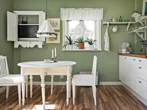 a kitchen with a table and chairs in a room at 2 person holiday home in RIMFORSA in Rimforsa