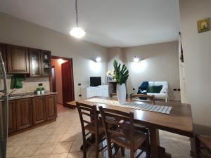a kitchen and dining room with a table and chairs at Villa Cruccuris in Villasimius +35 photos