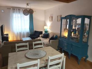 a living room with a blue cabinet and a table at Apartamento Valmojado in Madrid