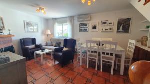 a living room with a couch and a table and chairs at Alojamiento Rural Fuente De La Glorieta in Cazorla