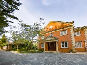 a brick house with a driveway in front of it at Gleneagles in Ascot