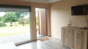 a living room with a sliding glass door at Nadmorskie Słońce in Lubin