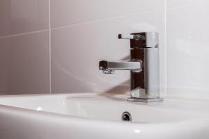 a bathroom sink with a chrome water faucet at Fantastic brand new Rooms in Bury