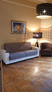 a living room with a couch and a lamp at Casa Tua a Porta Maggiore in Rome