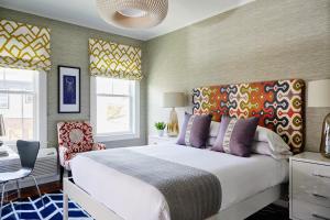 a bedroom with a large white bed and a chair at The Attwater in Newport