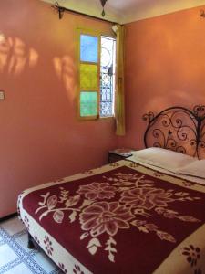 a room with a bed and a painting on the wall at Sindi Sud in Marrakesh
