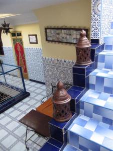 a row of blue and white fire hydrants in a room at Sindi Sud in Marrakesh