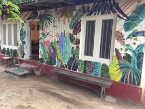 a building with a colorful mural on the wall at Catch The Ella Train Hostel in Kandy