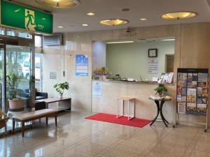 a lobby of a store with a waiting area and a counter at Hotel New Yutaka in Izumi-Sano