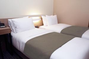 Postel nebo postele na pokoji v ubytování ON City Hotel