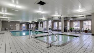 a large swimming pool in a large building at Holiday Inn Express and Suites St. Cloud by IHG in Saint Cloud