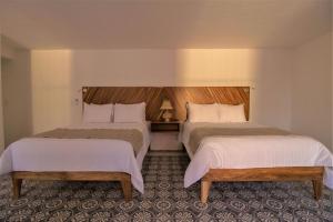 Postel nebo postele na pokoji v ubytování NaNa Vida Hotel Morelia