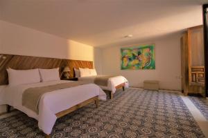 Postel nebo postele na pokoji v ubytování NaNa Vida Hotel Morelia