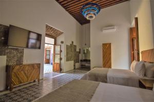Postel nebo postele na pokoji v ubytování NaNa Vida Hotel Morelia