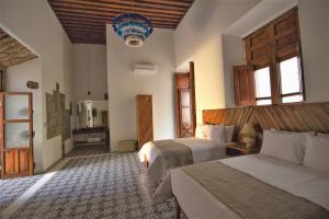 NaNa Vida Hotel Morelia tesisinde bir odada yatak veya yataklar